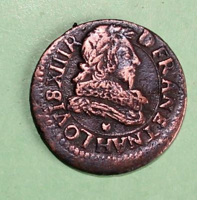 an old copper coin with a picture of a man on it