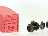 a pink box and two black knobs on a white surface