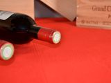 two bottles of wine sitting on a table next to a wooden box