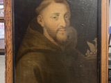 un vieux tableau représentant un homme barbu, dans un cadre en bois