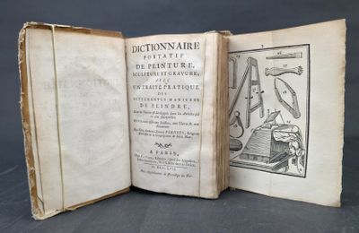 an old book opened to show a drawing of a man in a chair