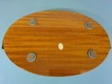 a wooden toilet seat with a button on it