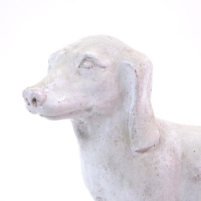 a statue of a dog that is sitting on a table