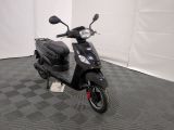 the motor scooter is parked on the floor in the room