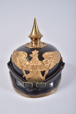 a black and gold helmet with a gold eagle on it