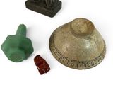 three pieces of pottery that are sitting on a white surface