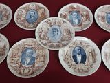 six brown and white plates with portraits of people on them