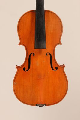 an old violin with a bow hanging from it ' s back