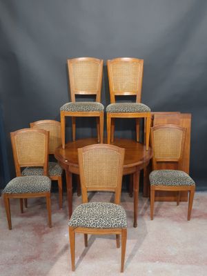 set of six dining chairs and a table with a leopard print upholstered seat