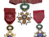 three medals and a ribbon on a white background