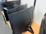 three computer monitors sitting on a desk next to each other