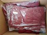 une boîte remplie de t-shirts rouges emballés dans du plastique