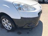 a white van parked in a parking lot with other cars in the background