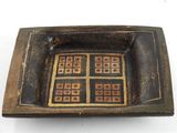 a brown and black bowl with squares on it