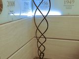 a lamp that is on a stand in the corner of a room
