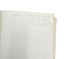 an open book with writing on it sitting on top of a table