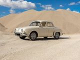 a car that is parked in front of a mountain of sand