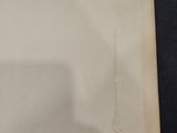an old photo of a piece of paper on a black surface