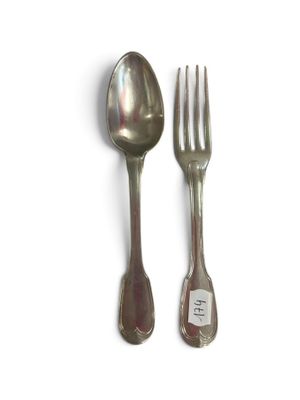 two silver spoons and a fork on a white surface
