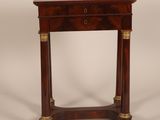a small wooden table with a drawer on top of it