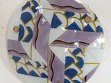 a blue and white plate with a design on it
