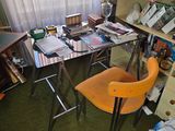 a desk and chair in a cluttered room with a lot of clutter on the floor