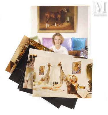 a picture of a woman sitting on a bed with a giraffe