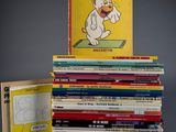 many books stacked on top of each other on a table
