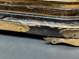 a close up of a gold statue on a black surface