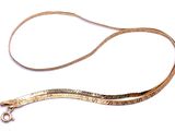 a long gold leash with a metal clasp on it
