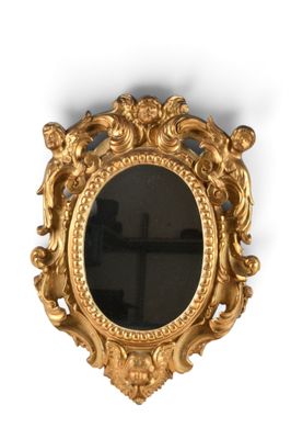 une image d'un miroir encadré d'or sur un mur blanc