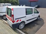 a white van parked in a parking lot next to a building