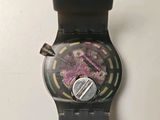 a close up of a watch on a white surface