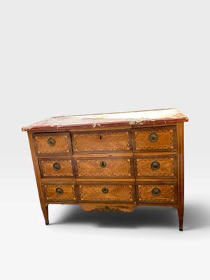 an antique chest of drawers with marble top