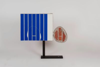 a close up of a blue and white object with a red object on it