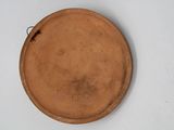 a brown plate on a white table with a brown handle