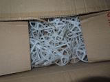 a cardboard box filled with shredded paper and scissors