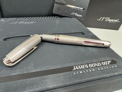 a silver pen sitting on top of a black box