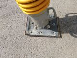 a yellow fire hydrant sitting on the side of the road