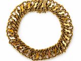 a close up of a gold chain bracelet on a white background