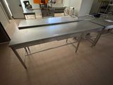 a kitchen with a table and a sink in it