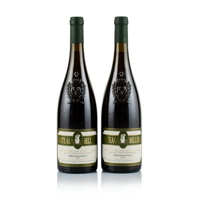 two bottles of wine sitting next to each other on a white surface