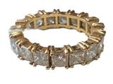 a close up of a gold ring with white diamonds on it