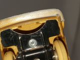 a close up of a yellow toy car with wheels