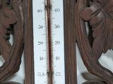 a thermometer on the wall that is hanging on the wall