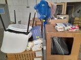 a pile of boxes and a chair in a room