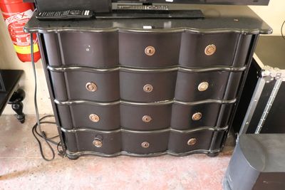 an image of a black dresser with a laptop on top of it