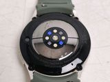 a close up of a watch on a white surface