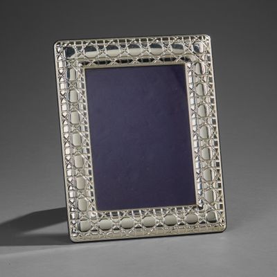 a silver picture frame with a blue glass in the center