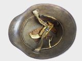 a metal bowl with a banana in it on a white surface